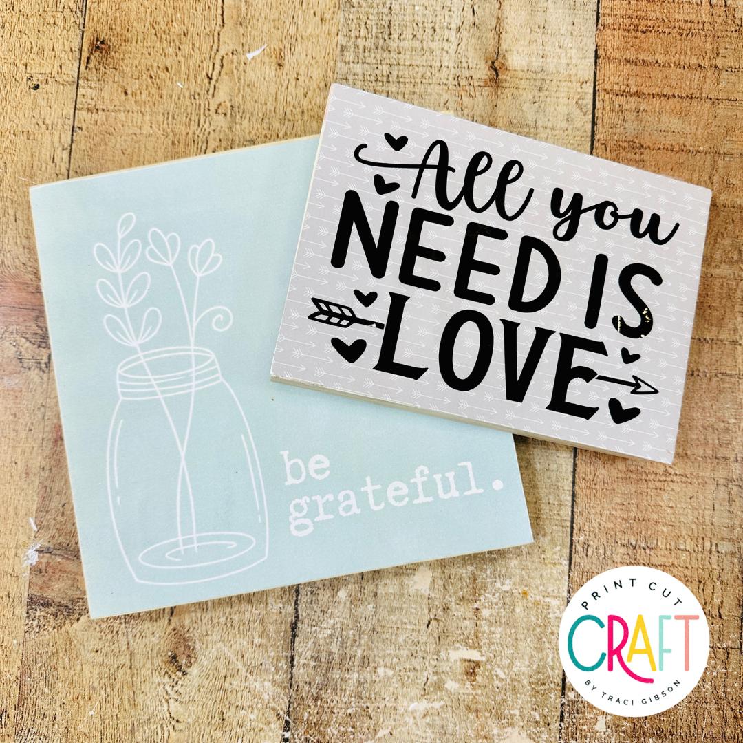 two small decoupage signs made with saran wrap