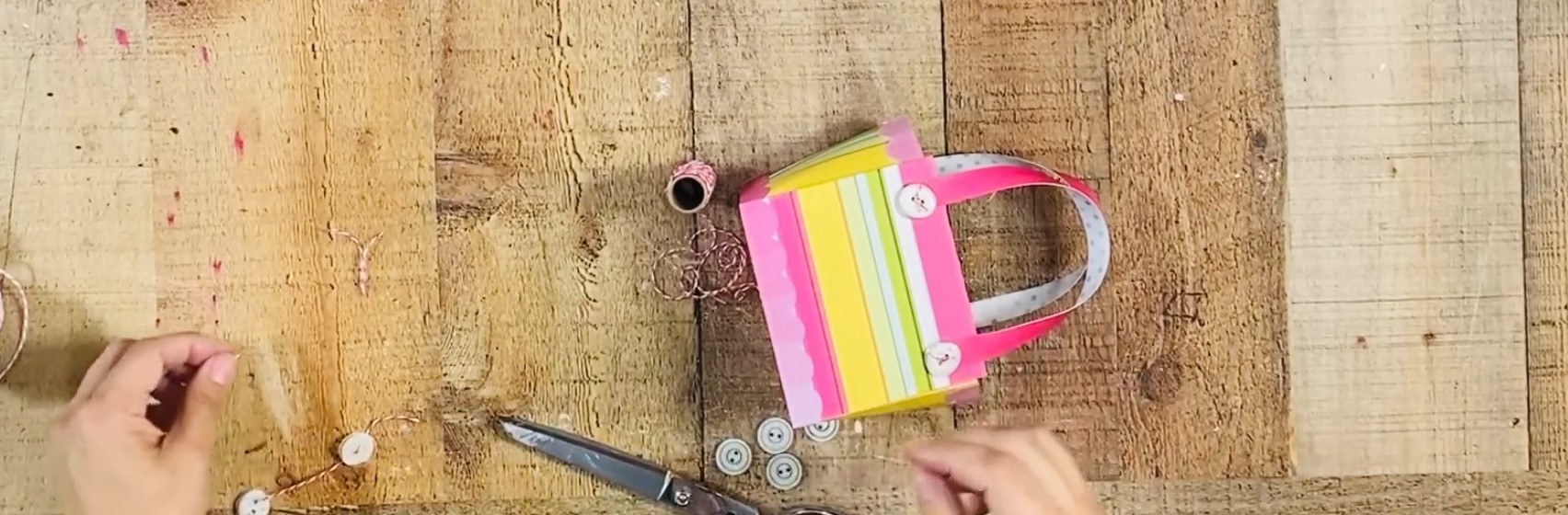 Add button embelishments to the bag.