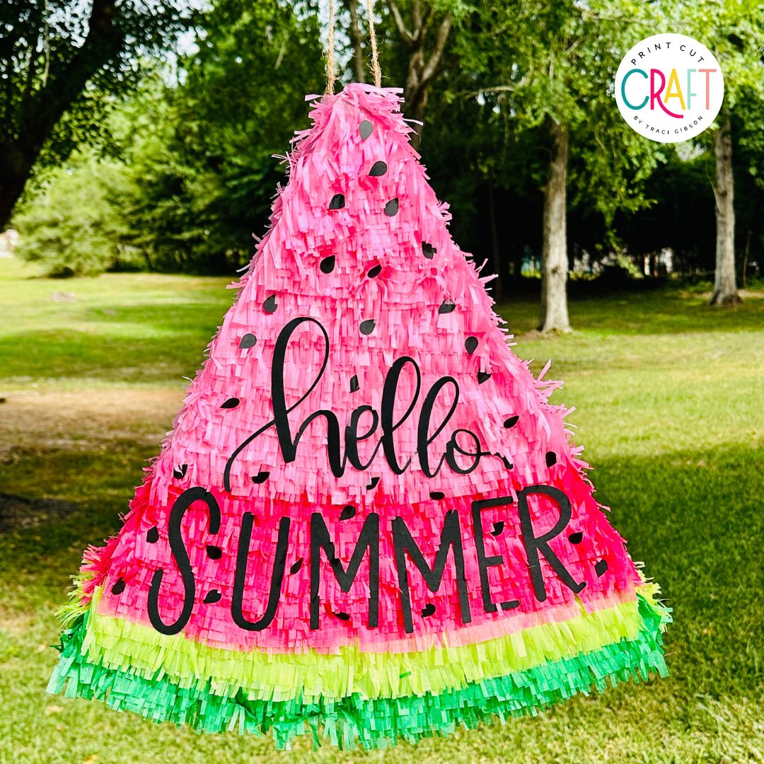 watermelon pinata hanging from a tree made with a cricut machine. 